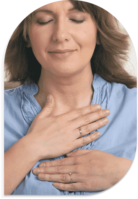 Woman holding hand to chest, showing calm and sincerity.